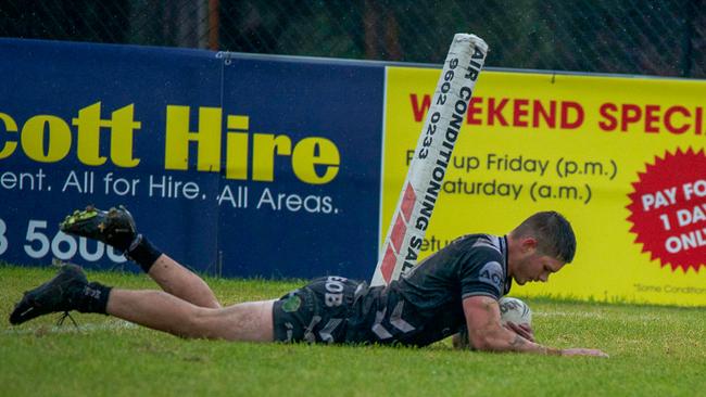 Benjamin Payne slides over for a Magpies try. Picture: Thomas Lisson