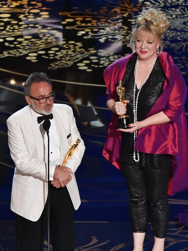 Production designers Colin Gibson (L) and Lisa Thompson accept the Best Production Design award for 'Mad Max: Fury Road'.