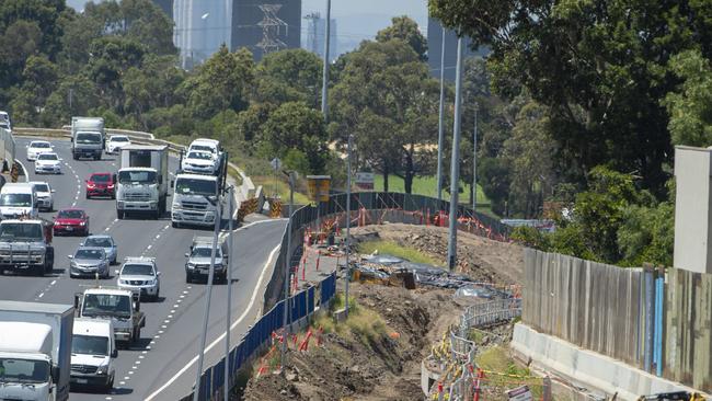 A mound of soil-covered in black tarp behind the barricades running along the Westgate Freeway. Picture: Jay Town