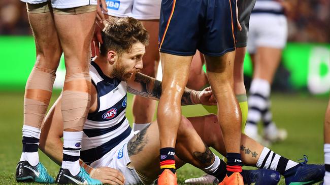 Zach Tuohy of the Cats is dazed after heavy contact from Taylor Walker of the Crows. Picture: Daniel Kalisz/Getty Images