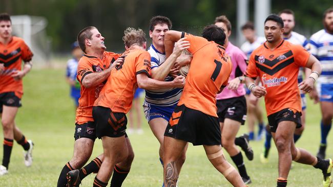 Action from the 2019 Cairns and District Rugby League (CDRL) match between Cairns Brothers and the Tully Tigers, held at Stan Williams Park, Manunda. Brothers' Evan Child is met with some tough defence. PICTURE: BRENDAN RADKE