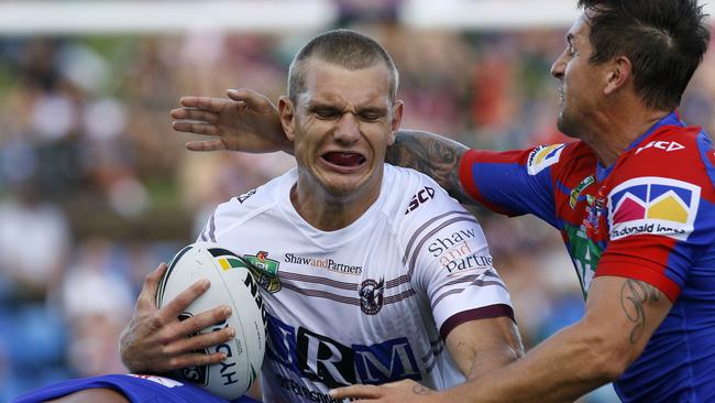 Tom Trbojevic of the Sea Eagles is tackled by Mitchell Pearce during the Round 1 NRL match between the Newcastle Knights and the Manly-Warringah Sea Eagles at McDonald Jones Stadium in Newcastle, Friday, March 9, 2018. (AAP Image/Darren Pateman) NO ARCHIVING, EDITORIAL USE ONLY