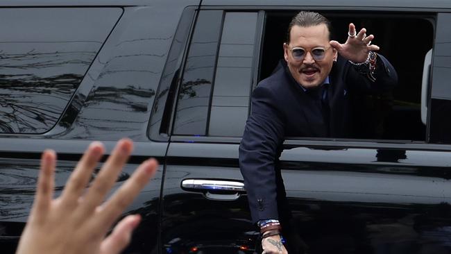 Actor Johnny Depp waves to supporters from his vehicle as he leaves a Fairfax County Courthouse May 27. Picture: Alex Wong/Getty Images