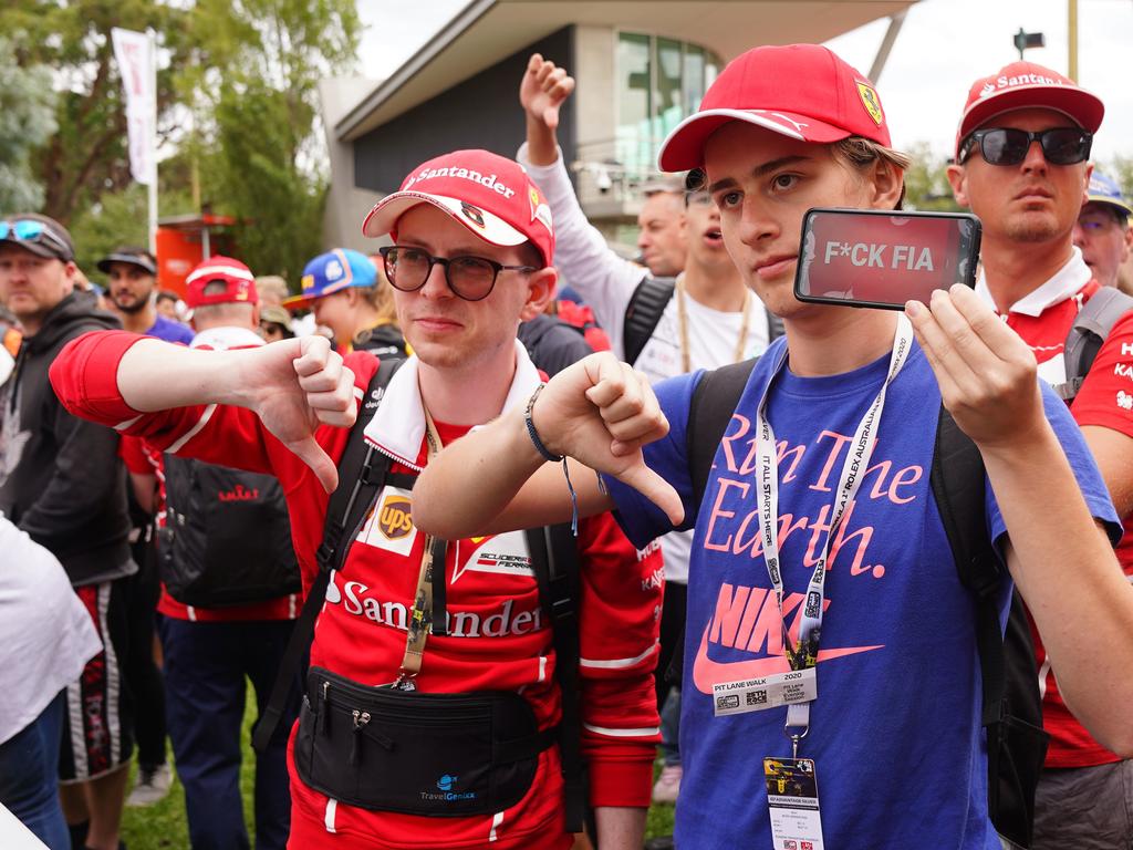 Spectators react after it was announced that the Formula 1 Australian Grand Prix 2020 was cancelled at the the Albert Park Circuit in Melbourne, Friday, March 13, 2020. Picture: AAP Image/Scott Barbour