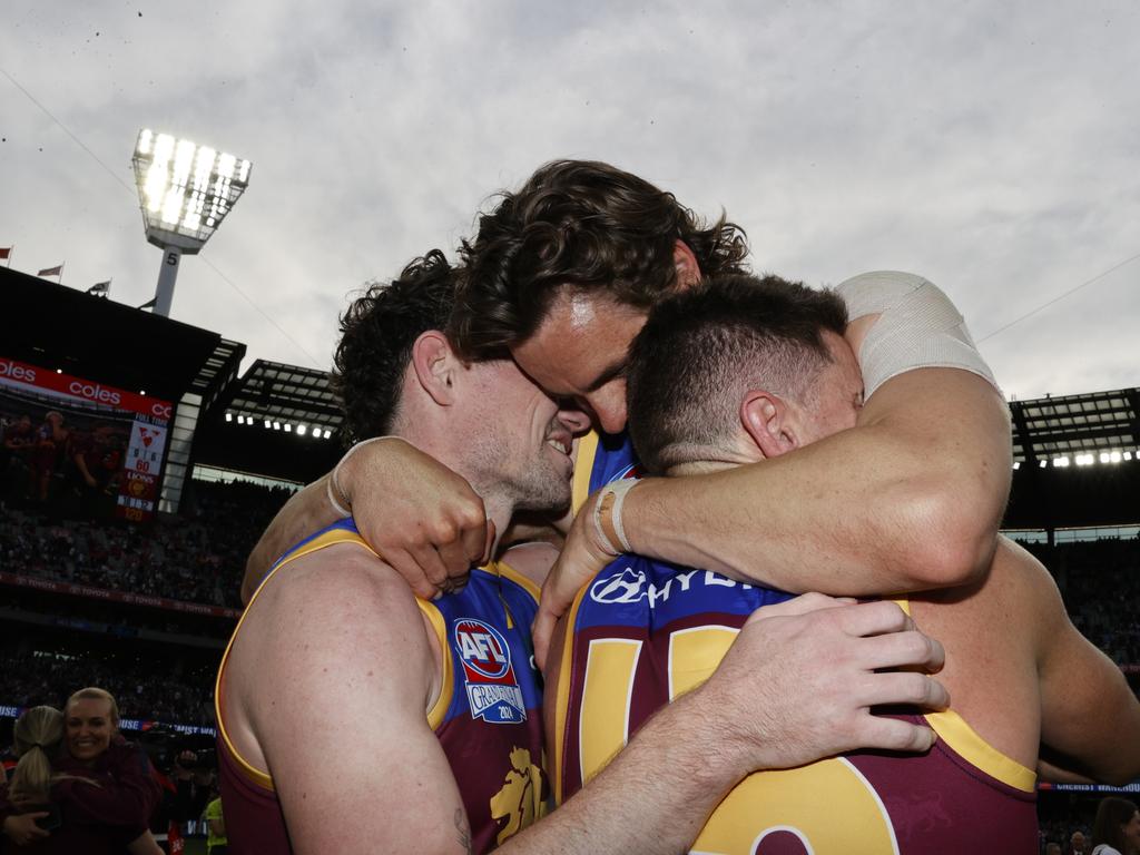 Lachie Neale, Joe Daniher and Dayne Zorko of the Lions embrace after the final siren. Picture: Darrian Traynor/AFL Photos/via Getty Images.