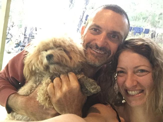 Shauli, the three-year-old cavoodle, with her owners.