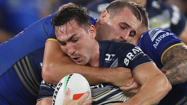 SYDNEY, AUSTRALIA - APRIL 13: Reece Robson of the Cowboys is tackled by Reagan Campbell-Gillard of the Eels during the round six NRL match between Parramatta Eels and North Queensland Cowboys at CommBank Stadium on April 13, 2024 in Sydney, Australia. (Photo by Jason McCawley/Getty Images)