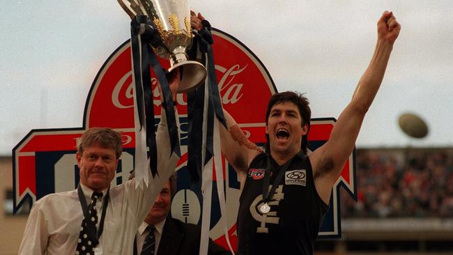 Stephen Kernahan and David Parkin holding the 1995 AFL Premiership Cup.