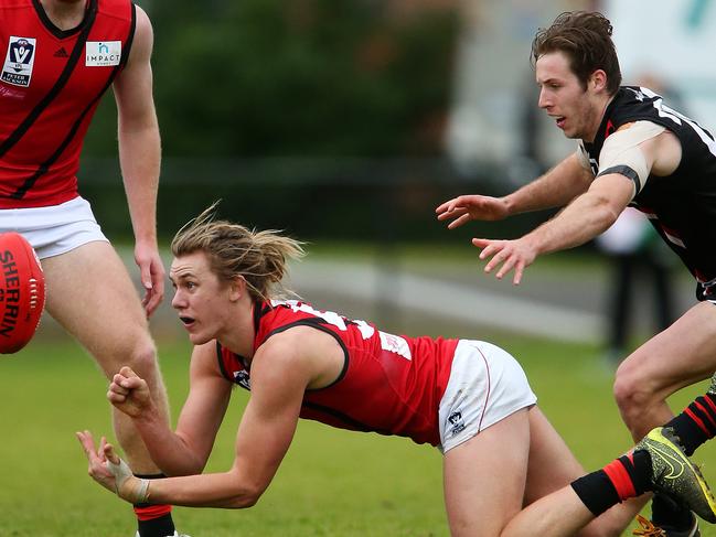 Aaron Heppell shovels out a handball for Essendon VFL. Picture: Mark Stewart