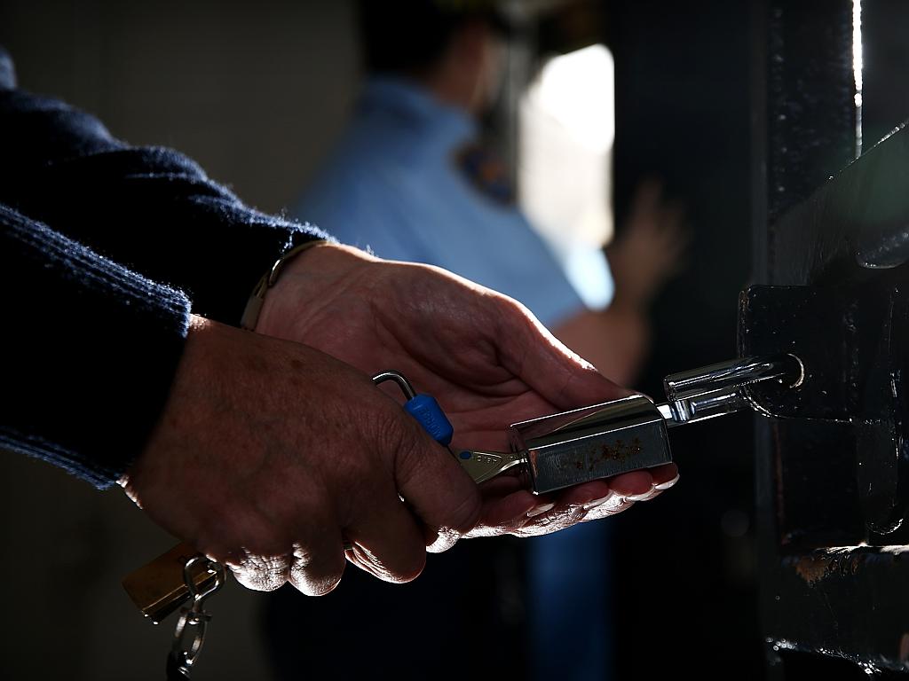 A guard opens a lock on a prison cell gate at the Brush Farm Corrective Services training headquarters in Eastwood. Picture: Tim Hunter