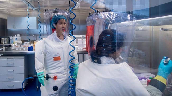 Chinese virologist Shi Zhengli, left, inside the P4 laboratory in Wuhan. Picture: AFP