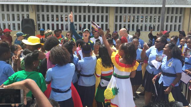 Ellyse Perry dancers with school children in Guyana.