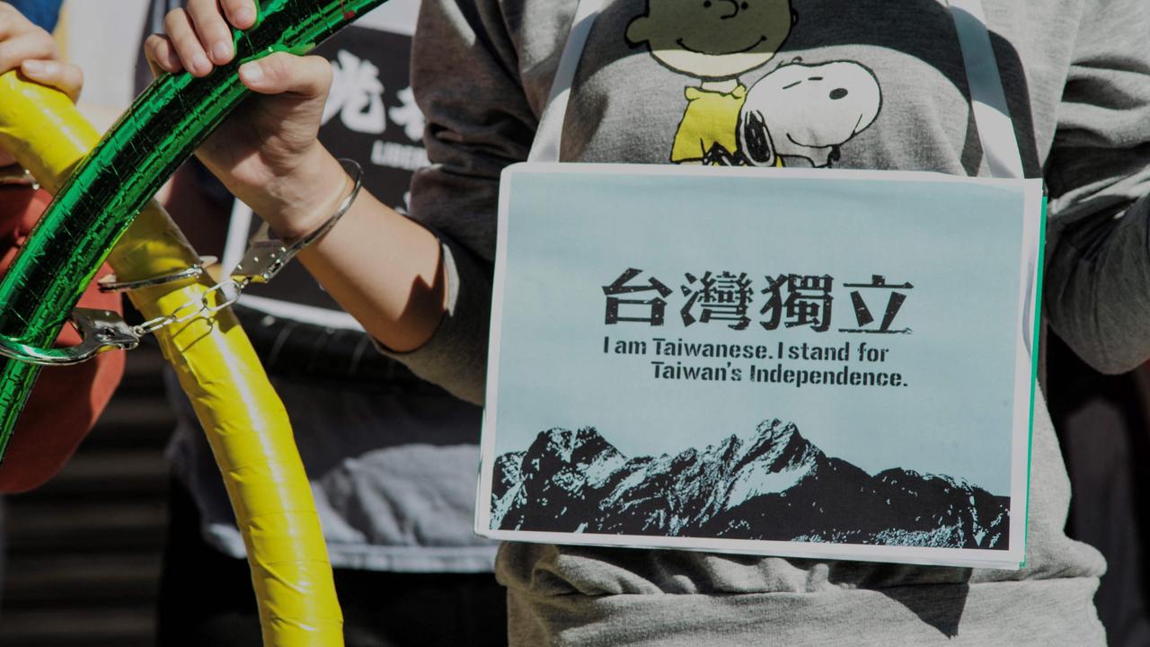 Activists hold up the five Olympic Rings to protest against the 2022 Beijing Olympic Games, which begin on February 4, outside the Parliament in Taipei on January 26. Picture: Sam Yeh/AFP