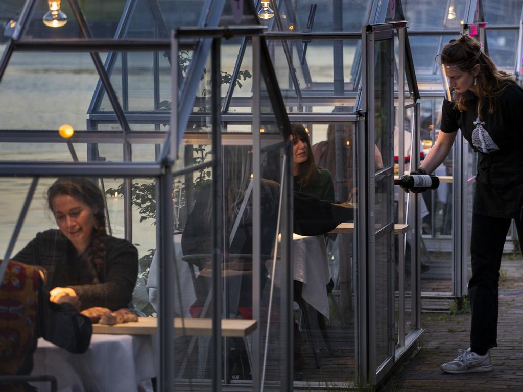 The volunteers are in small glasshouses during the trial on Tuesday. Picture: AP Photo/Peter Dejong
