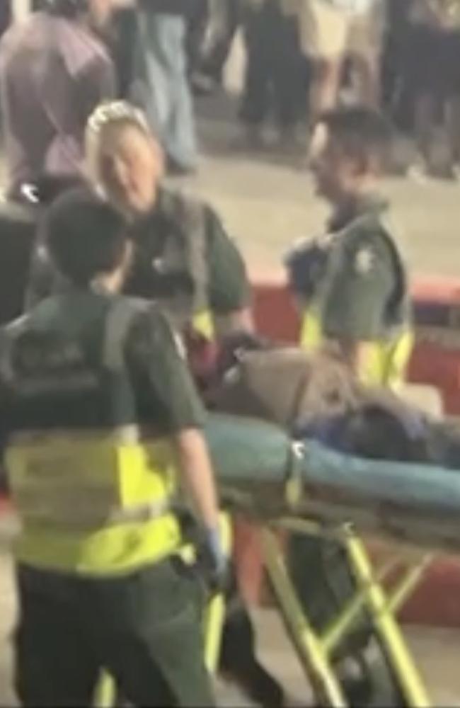 The fan was taken away on a stretcher. Picture: Supplied