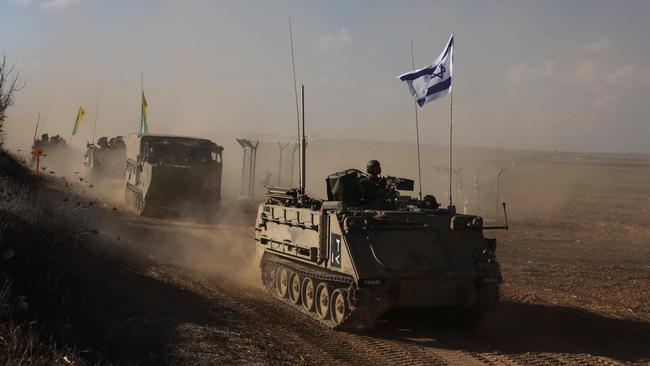 A convoy of Israeli military vehicles drives down a road at an undisclosed location on the border with the Gaza Strip. Picture: AFP