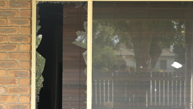 A broken window at the Norlane property where a gunshot was fired. Picture: Alan Barber