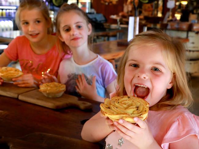 Cameryn, 9, Sophine, 8, and Indiana, 5, try an Invictus Pie at Glenorie Bakery. Pictures: Angelo Velardo