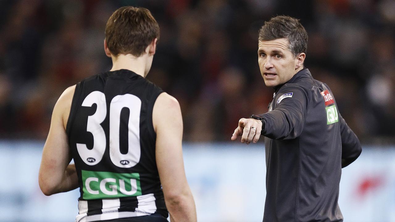 Magpies assistant coach Justin Longmuir speaks with Darcy Moore on Friday night.