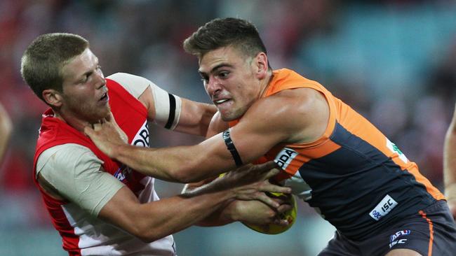 Stephen Coniglio tries to break free of Dan Hannebery’s tackle during GWS’ first match. Picture: Phil Hillyard.