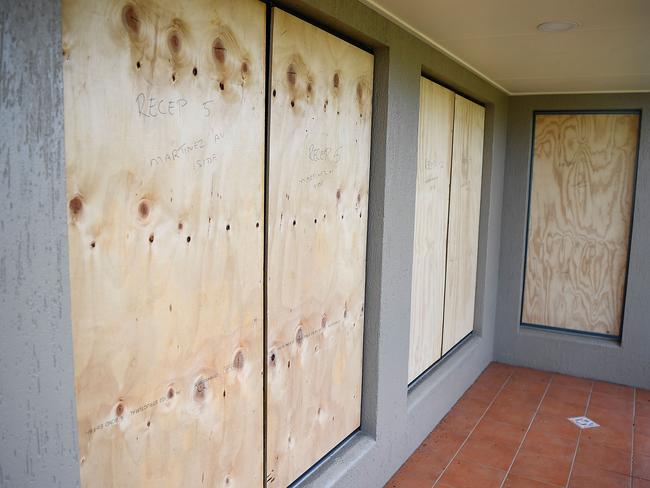 Windows are boarded up with plywood at a funeral home in Townsville as residents prepare for Cyclone Debbie. Picture: Ian Hitchcock/Getty Images