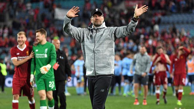 Liverpool coach Jurgen Klopp waves.