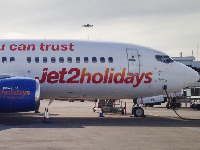 Yeadon, UK - April 16, 2014: Jet2 airplane parked at Leeds Bradford international airport on the West Yorkshire. Jet2 a British low-cost regional airline group based in Leeds, England that operates flights across uk and europe. This airport is situated in Yeadon on the metropolitan area of Leeds, it's an Hub for Ryanair, Transavia and Jet2. The airplane is an Airbus A320-200. Image taken in the afternoon on a cloudy day.