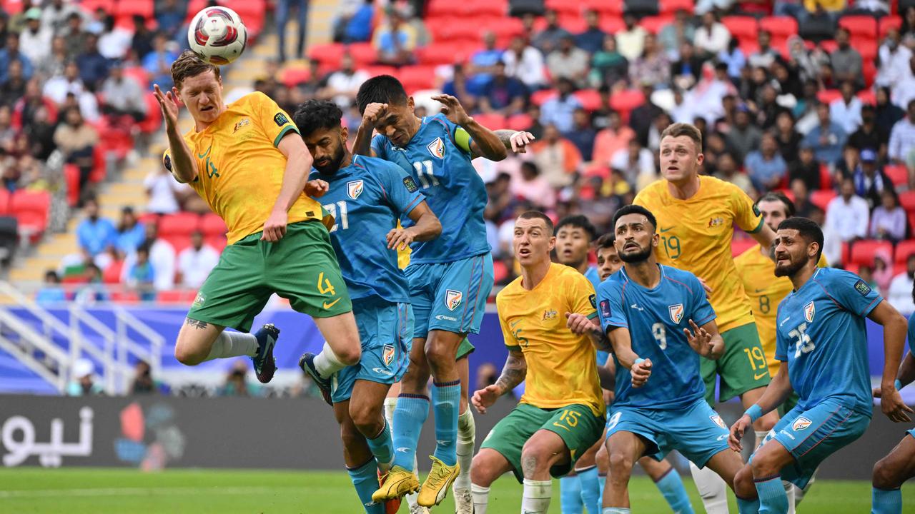 Kye Rowles (left) rises high to head the ball during the Socceroos’ 2-0 win over India. Picture: Hector Retamal/ AFP