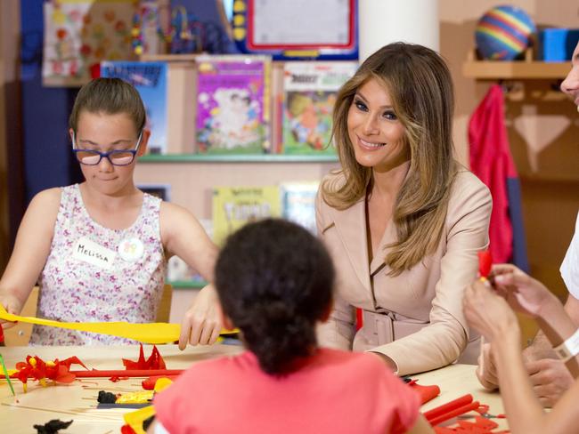 Melania Trump participates in a crepe paper flower making workshop at the Queen Fabiola Childrens Hospital in Brussels. Picture: Virginia Mayo