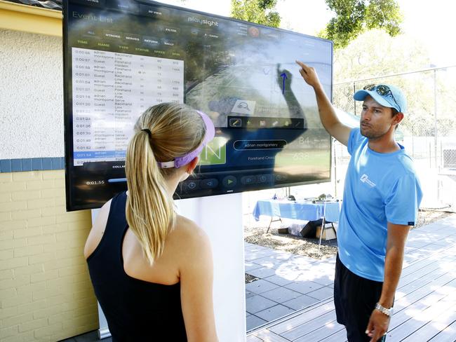 Ms Hinchcliffe checks out her shots and stats on the PlaySight screen with Mr Montgomery. Picture: John Appleyard