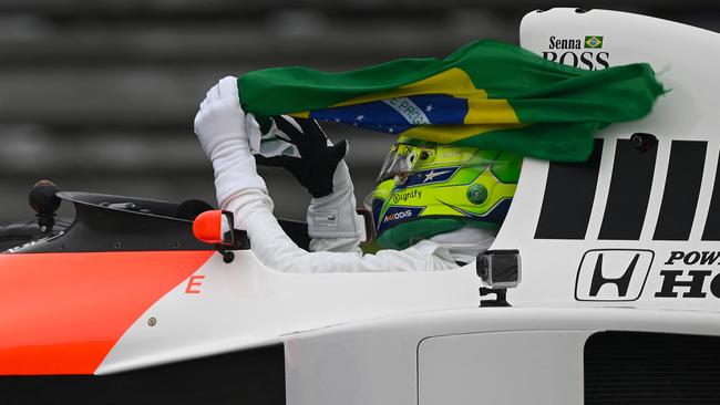 Lewis Hamilton of Great Britain and Mercedes holds a Brazll flag as he drives the 1990 McLaren MP4/5 in tribute to the late Ayrton Senna on track prior to the F1 Grand Prix of Brazil at Autodromo Jose Carlos Pace in November 2024 in Sao Paulo, Brazil. Picture: Clive Mason/Getty Images