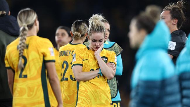 Australia's players react at the end of the Australia and New Zealand 2023 Women's World Cup semi-final football match between Australia and England at Stadium Australia in Sydney on August 16, 2023. (Photo by FRANCK FIFE / AFP)