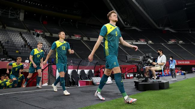 Harry Souttar #5 walks out in front of Mitch Duke #12 and Connor Metcalfe #17 for Team Australia in the Tokyo 2020 Olympic Games at Sapporo Dome on July 22, 2021 in Sapporo, Hokkaido, Japan. (Photo by Masashi Hara/Getty Images)