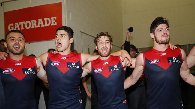 Relieved Demons players sing the song after their late comeback. Pic: AAP