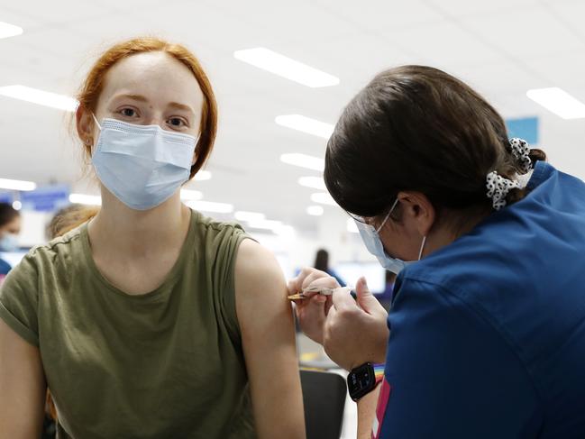 Nurse Zoe Robinson giving Amy Yarrow, 18, her second COVID-19 vaccination at the Sydney Olympic Park NSW Health vaccination centre. Picture: Jonathan Ng