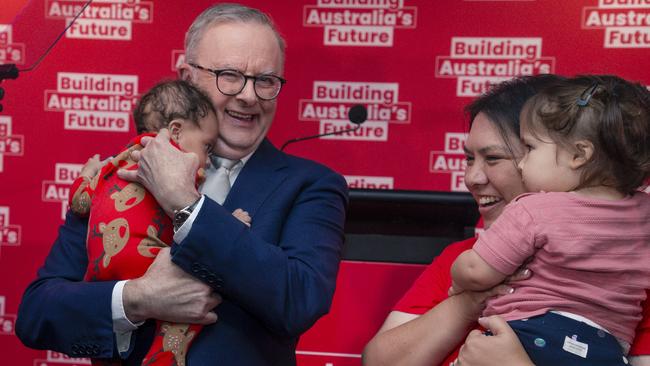 Prime Minister Anthony Albanese holds baby Maise after delivering a speech at the Morningside Panthers AFL club in Brisbane. Picture: NewsWire / Glenn Campbell