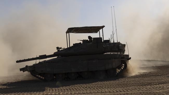 An Israeli tank moves a long the border after leaving the Gaza Strip. Picture: Getty