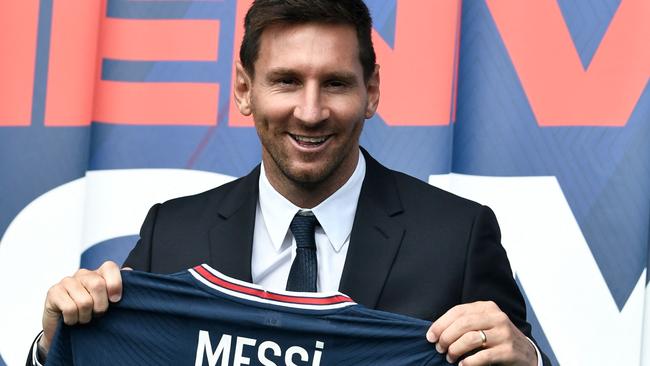 Lionel Messi poses with his new PSG shirt. Picture: AFP