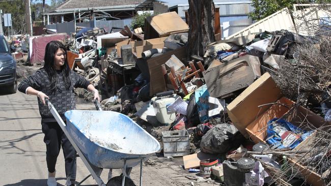 Maribyrnong residents cleaning up during last year’s floods. Picture: David Crosling