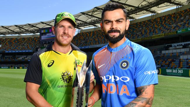 Aaron Finch (left) of Australia and Virat Kohli (right) of India are seen posing for a photo at the Gabba in Brisbane, Tuesday, November 20, 2018. Australia are playing India in game one of a three match international T20 series at the Gabba on Wednesday. (AAP Image/Darren England) NO ARCHIVING