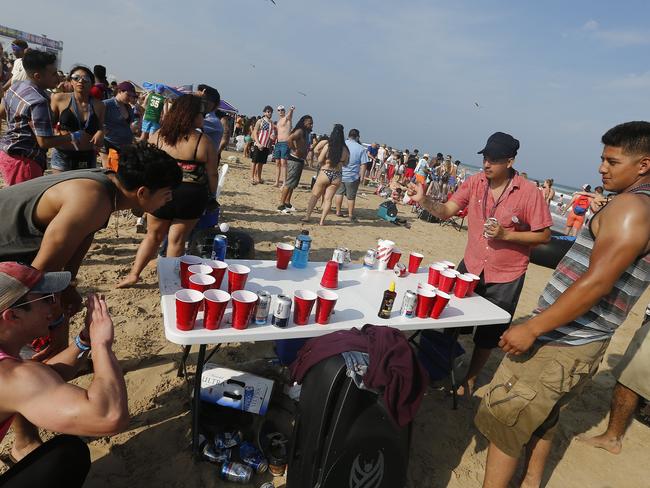 People celebrate on the beach at Clayton's Beach Bar and Grill in South Padre Island. Picture: EPA/Larry W. Smith