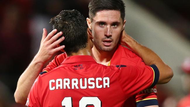 Adelaide United’s Marcelo Carrusca and Dylan McGowan celebrate the win over Newcastle on Friday night.