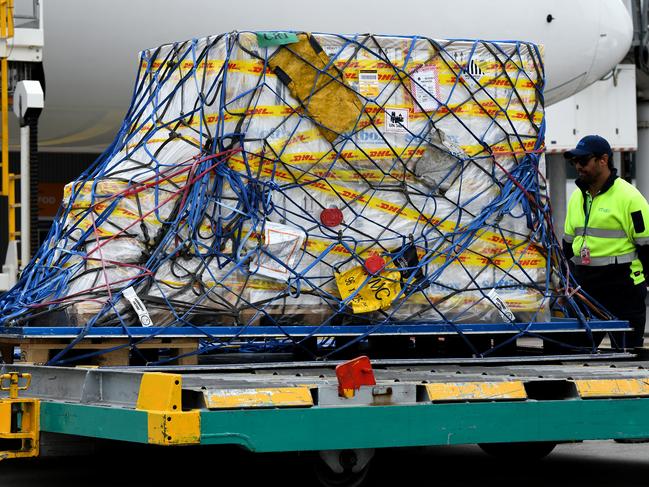 The first Australian shipment of Pfizer COVID-19 vaccines is seen on the tarmac after being unloaded from a Singapore Airlines plane at Sydney International Airport on Monday, February 15, 2021. More than 142,000 doses of the Pfizer/BioNTech COVID-19 vaccine have arrived at Sydney airport in Australia's response to the pandemic. This is the first shipment of 20 million doses of the Pfizer vaccine the Government has secured as part of Australia's COVID-19 Vaccine and Treatment Strategy. Picture: AAP Image/Pool/Bianca De Marchi