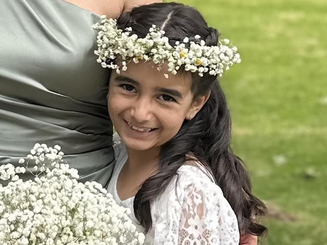 Eliyana Salmanzadeh, 8, who was diagnosed with neuromyelitis optica (NMO), with her family, dad Matthew, mum Mahsa and brother Cyrus. Picture: Supplied by family