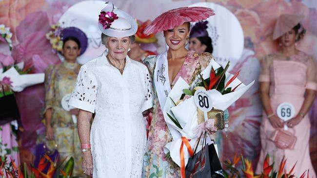 Fashions on the Field judge Bernice Patton presents Brittany Tamou the Open Classic Ladies Race wear winner's sash at Cairns Amateurs Cup Day, the final day of the Cairns Amateurs racing carnival. Picture: Brendan Radke