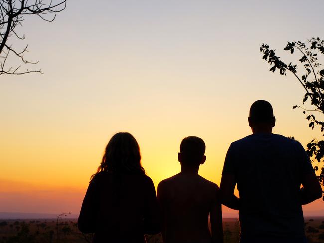 Silhouettes of a family watching the beautiful sunset in Mikumi National Park.