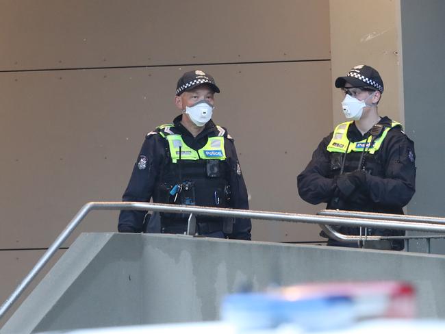 Police keep watch on the towers in Racecourse Rd. Picture: David Crosling