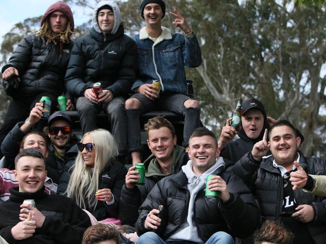 Footy fans sitting down to drink their beer. Picture: Emma Brasier.