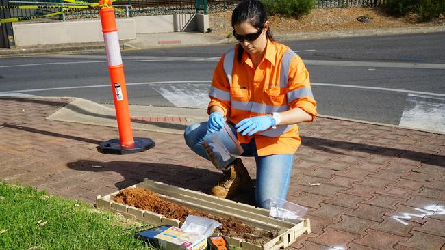 An Environment Protection Authority (EPA) worker tests soil for contamination.