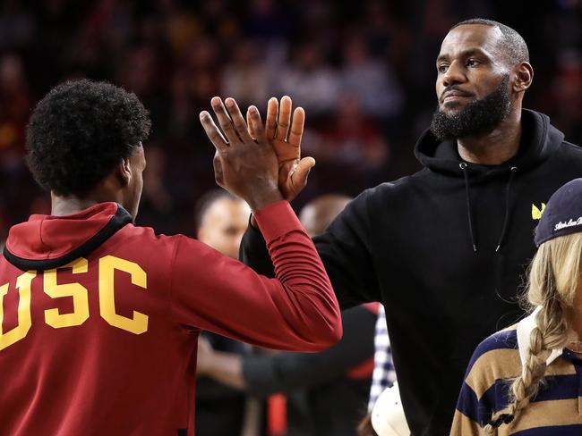LeBron with his son before a college basketball game. Picture: Meg Oliphant/Getty Images